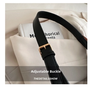 Detail of adjustable black leather strap with premium gold metal buckle and stitching