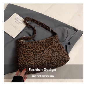 Detail of hobo bag featuring leopard print fabric and a secure zipper closure system