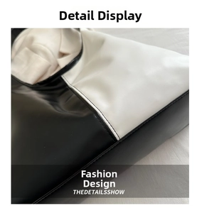 Close-up of black and white contrast stitching details on premium PU leather tote bag