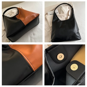 Detail of color-block leather tote showing stitching, magnetic clasp and hobo structure