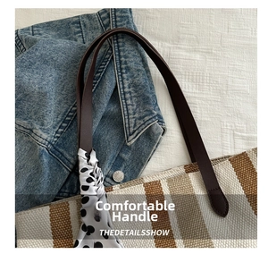 Detail of striped canvas tote with dark brown leather handle and polka dot silk scarf