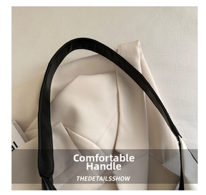 Detail of premium black leather shoulder strap on a minimalist large capacity tote bag