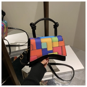 Macro shot of colorful geometric color-block handbag with distinctive curved base design