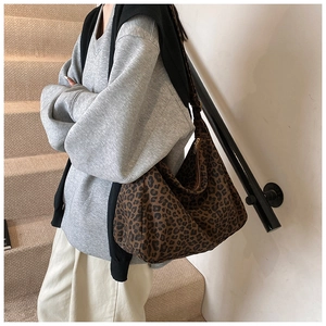 Detail of leopard print tote bag showing the texture and large capacity on a model