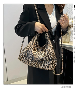 Detail of leopard print large hobo tote bag with adjustable strap worn on shoulder
