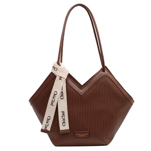 Brown pleated tote bag with vertical texture and decorative ribbon on a white background