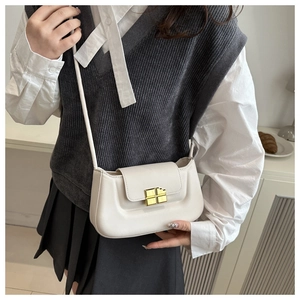 Detail of a vintage off-white mini crossbody bag featuring a golden square twist lock