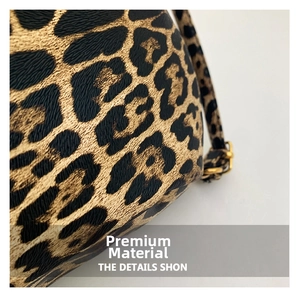 Macro detail of leopard print fabric texture and golden metal buckle on shoulder bag