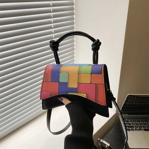 Black leather crossbody bag with colorful geometric patterns and knotted handle detail
