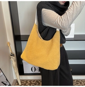 Detailed view of yellow fleece tote bag on shoulder showing soft texture and large capacity