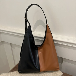 Chic black and brown color-block Hobo shoulder bag for women on a minimal background