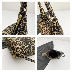 Detail view of large leopard print bucket bag featuring gold hardware and zipper closure