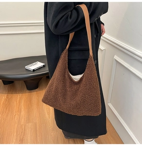 Brown teddy fleece tote bag with leather handles shown over a model shoulder