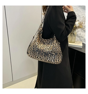 Detail view of large leopard print bucket bag in soft faux leather for casual shoulder wear