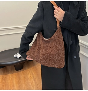 Detail of soft dark brown faux shearling tote bag with premium leather shoulder strap