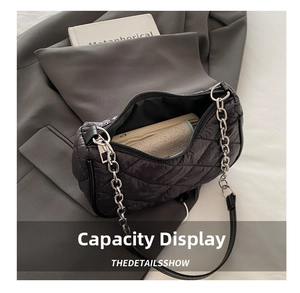 Internal view of black quilted nylon bag showing spacious capacity for phone and umbrella
