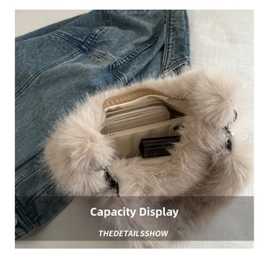 Spacious interior of beige faux fur shoulder bag holding a wallet and smartphone