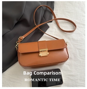 Detail of a brown leather crossbody bag featuring a classic gold rectangular metal clasp