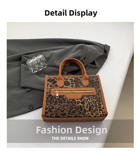 Detail view of leopard print tote bag with brown leather trim and metal zipper feature