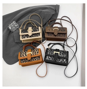 Close-up of four leopard print handbags with gold buckles in various autumn colors