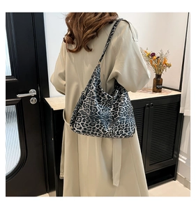 Detailed view of the large leopard print hobo bag with matching patterned shoulder strap