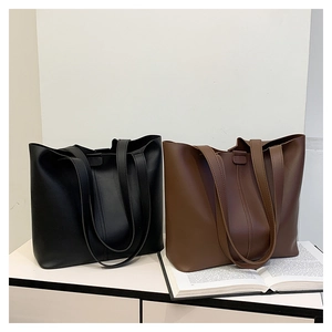 Minimalist large bucket tote bags in black and brown leather with double straps