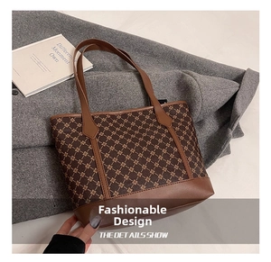 Detail showing vintage brown patterned tote bag texture on a stylish wool coat