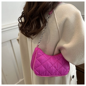 Close-up of hot pink quilted nylon shoulder bag with silver chain and crescent design