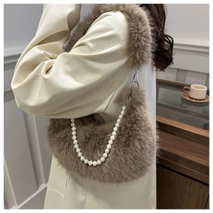 Brown faux fur baguette bag with pearl chain strap shown in a cozy cafe setting