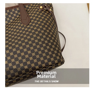 Detailed macro shot of vintage brown monogram tote bag with gold floral pattern and rivets