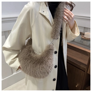 Close-up of brown plush shoulder bag with silver metal ring and soft fur texture