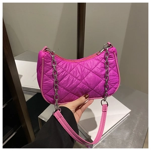 Close-up of rose pink quilted nylon shoulder bag with silver chain and puffy texture