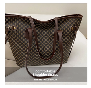 Detail of vintage pattern tote bag featuring dark brown geometric print and leather straps