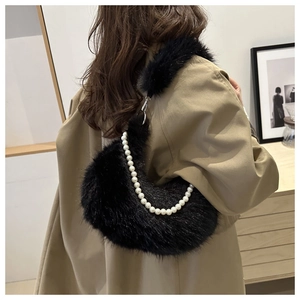 Detail of plush black crescent underarm bag with faux pearl chain and fluffy texture