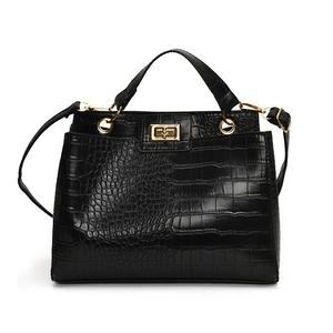 Minimalist black trapezoid handbag with crocodile pattern and golden metal twist lock