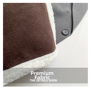 Close-up of brown suede fabric with white fleece lining and flat stitching details