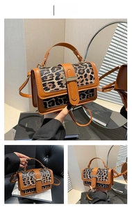 Detailed view of leopard print crossbody bag in brown with gold metal buckle and strap