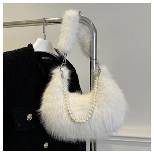Detail of white plush crescent bag featuring elegant pearl strap and fluffy texture