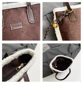 Detail view of winter brown suede tote with faux fur trim, zipper closure and logo tag