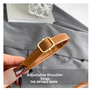 Detail of adjustable caramel brown faux leather shoulder strap with gold alloy buckle