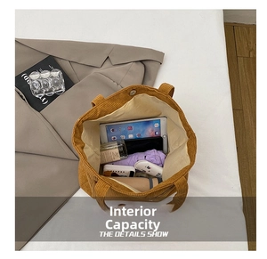 Detailed interior of corduroy tote bag showing large capacity for tablet and daily items