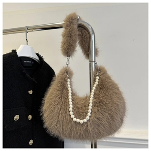 Detail of brown plush faux fur hobo bag with elegant pearl chain and thick shoulder strap