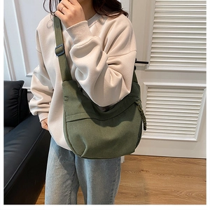 Close-up of military green corduroy hobo bag showing ribbed texture and wide strap