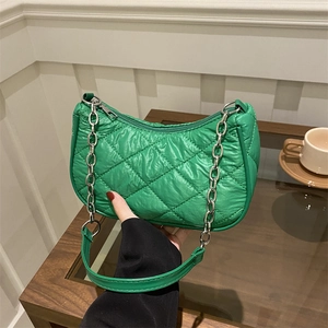 Quilted green shoulder bag with silver chain strap in a stylish minimalist design