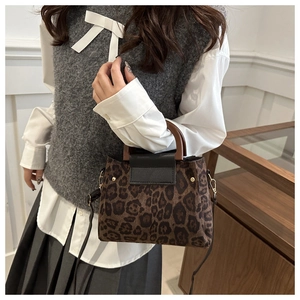 Leopard print crossbody bag with vintage wooden handles and golden hardware detail