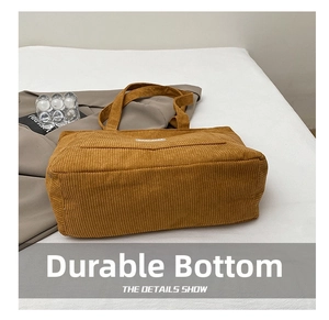 Detailed view of the reinforced durable base of this ginger corduroy tote bag