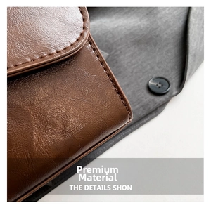 Detailed macro view of brown leather texture and stitching on the small square bag