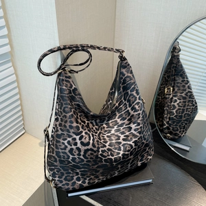 Large leopard print hobo bucket bag with adjustable strap and soft faux leather texture