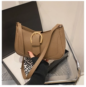 Detail of dark khaki lychee leather shoulder bag with vintage gold horseshoe buckle