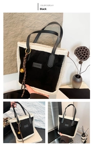 Detail of suede tote bag with faux shearling trim and decorative fashion logo tag